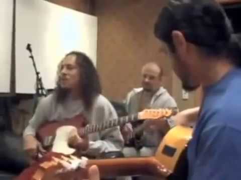 Robert Trujillo plays acoustic guitar