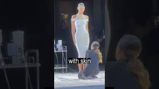 Liquid dress on a naked model at a fashion show in