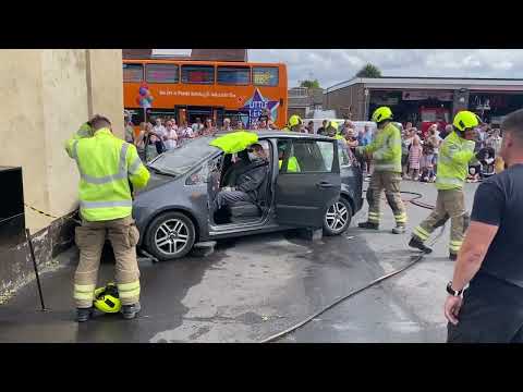 mannequin-man performming as a drag dummy: Essex Fire & Rescue crew demonstrating the process of extracting a trapped casualty from a road traffic accident using mannequin man as a casualty rescue dummy at Grays Fire Station open day for Essex Fire Museum on 04/09/2022