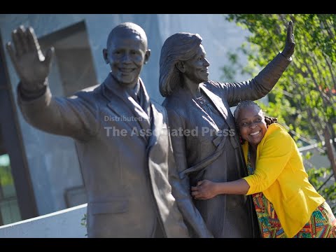 Barack and Michelle Obama greet the first visitors of presidential center