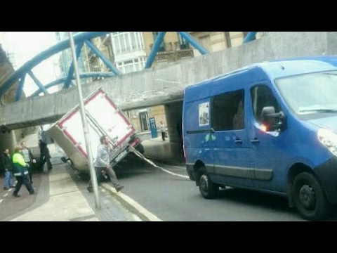 RESCUED TRUCK about to overturn and fall down a bridge