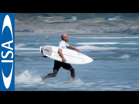 Kelly Slater sprints up the beach