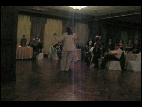  Adrian Costa  and  Amanda Costa  are  dancing  to  the  tango  "  Infamia  "