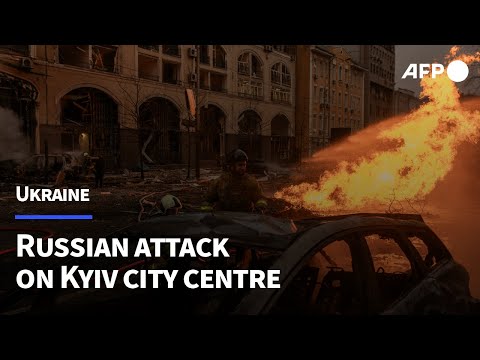 Damage buildings and burning cars in Kyiv city centre following Russian attack | AFP