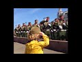 Russian soldiers give a military greeting to the little girl