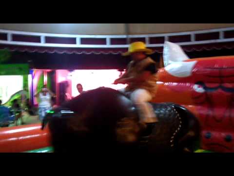 cowboy smurf  rides a bull