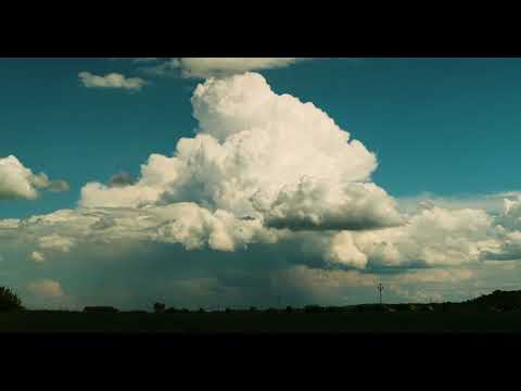 Timelapse of spectacular huge cumulonimbus cloud billowing on the horizon
