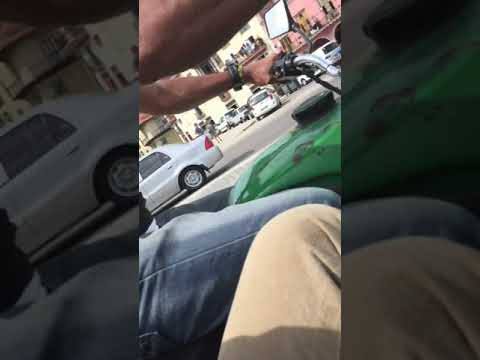 Conan in Cuba hanging on for dear life in the side car of a motorcycle