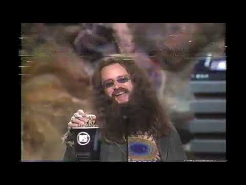 1999 MTV Movie Awards - 'Hippy' Jim Carrey accepts award with Mike Meyers and Janeane Garofalo