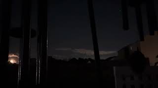 windchimes blowing with the harvest moon in the back