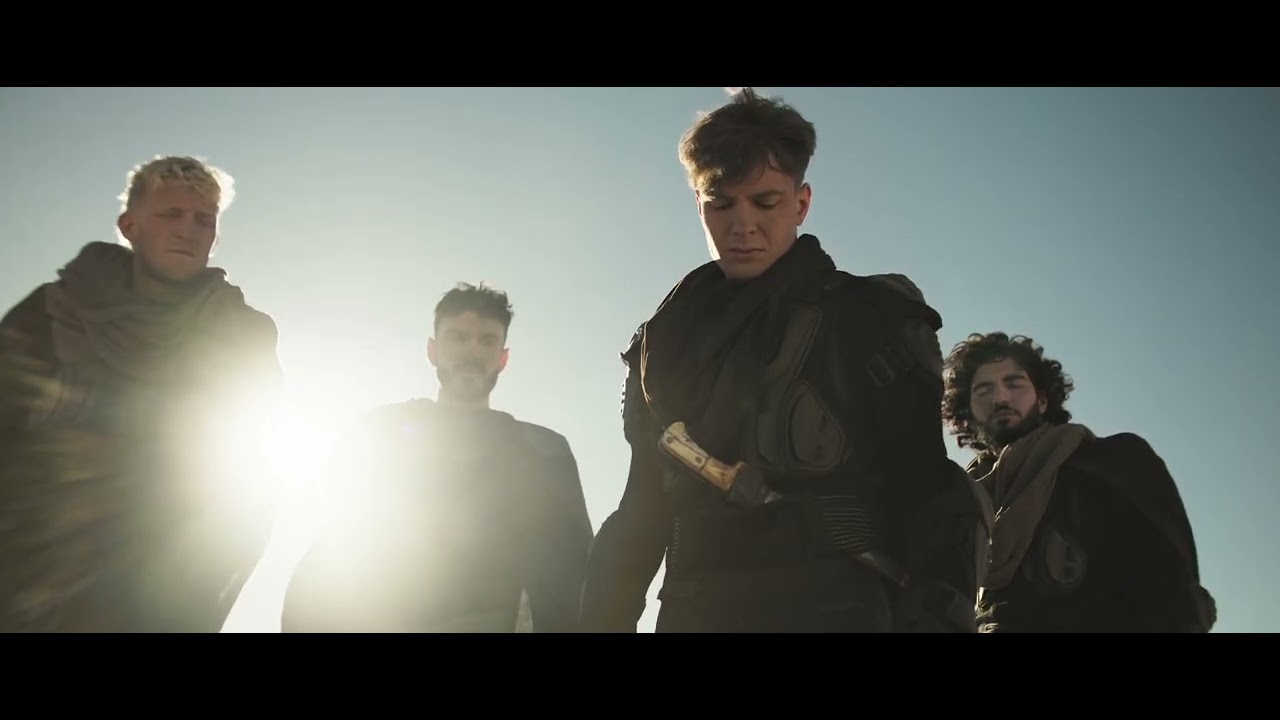 Four costumed actors walking in desert sunlight in the Finalmouse Prophecy film
