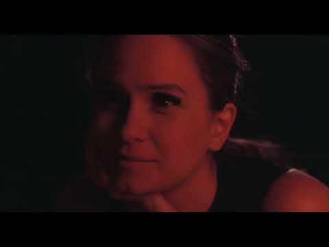 Trailer close-up: Doc squints into sun; a Greenwood string figure hangs in the heat