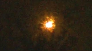 Orange UFO Emits Sparks while Changing Shape