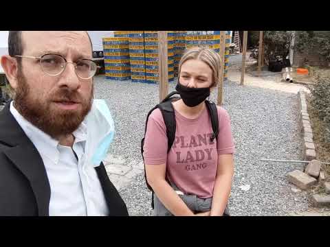 A Rabbi and an animal rights activist have a conversation at Kaparot