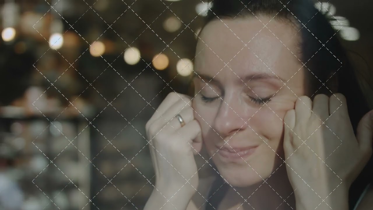 Close up of woman holding cell telephone in a caffe. Talking to someone loved on mobile phone during