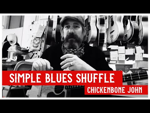 Learning the basics of a simple blues shuffle on Cigar Box Guitar, with Chickenbone John