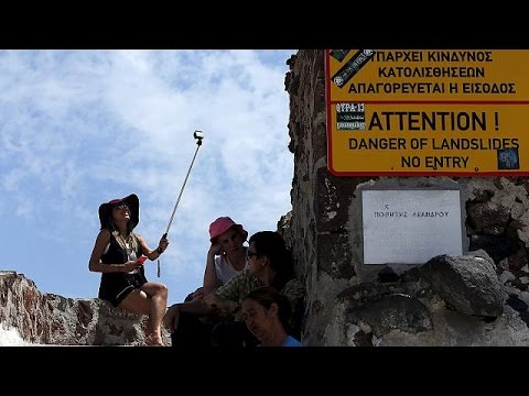 Tourists enjoying Mykonos sun aware of Greek hosts' dark clouds