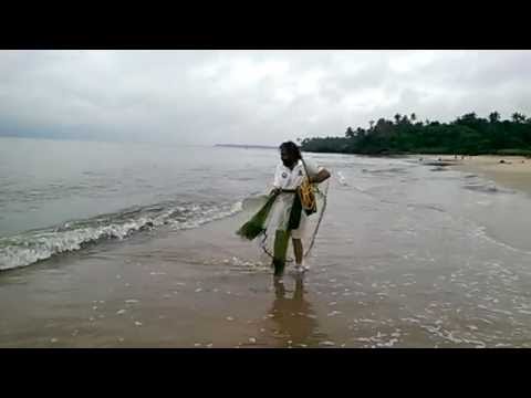 nazir casting 12 foot a fishing net at Thottada beach