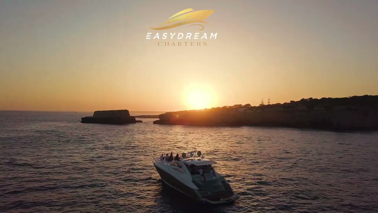 Sail along the Algarve coast with vibrant sunset.