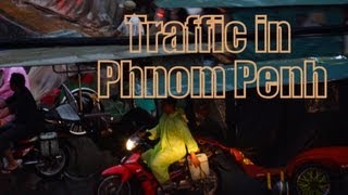 Crazy traffic in Phnom Penh, Cambodia during a storm with heavy rainfall, wind and thunder