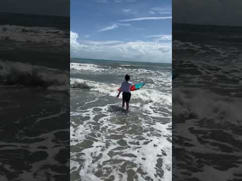 rayne walking out in waves