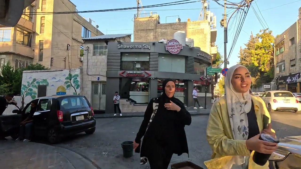 Immersive street-level walking tour through Amman Rainbow Street, Jordan, showcasing authentic urban landscapes, local architecture, and the vibrant atmosphere of the city's neighborhoods