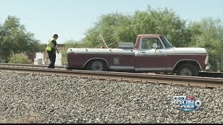 Train stops in time, avoids collision with truck on tracks