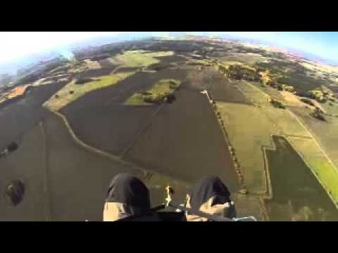 This paraglider was soaring in the sky when an airplane flew underneath him.