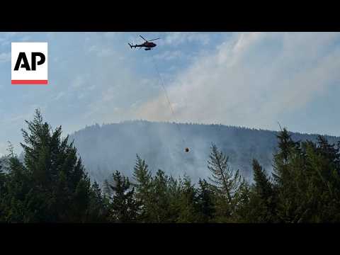 Helicopters battle wildfires in western Canada