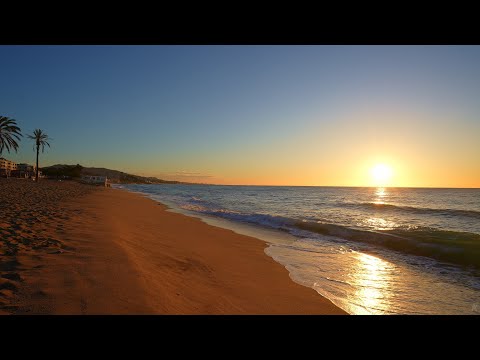Relaxing walk on the beach at sunrise in the Mediterranean