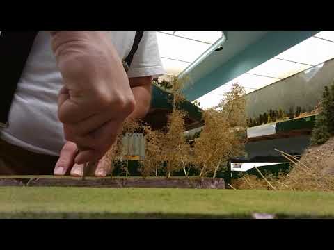 Preparing trees made out of seafoam armatures putting them into a foam board