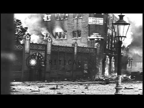 Smoke rises from flaming vehicles and buildings in Nijmegen, Holland. HD Stock Footage
