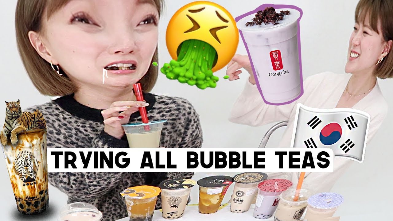 Several cups of Korean bubble tea with different flavors and pearl toppings displayed at a row of Hongdae boba shops
