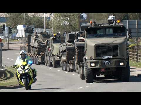 Convoys of tanks being transported for the British Army with a police escort through Wales