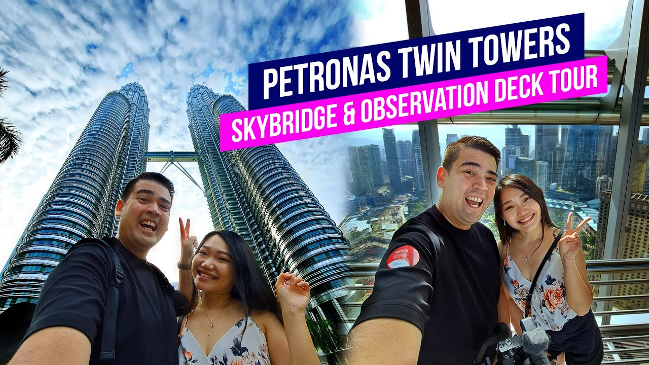 Join tourists as they explore the majestic Petronas Twin Towers in this enthralling video.