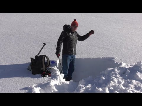Avalanche experts demonstrate snow stability test to gauge avalanche risk