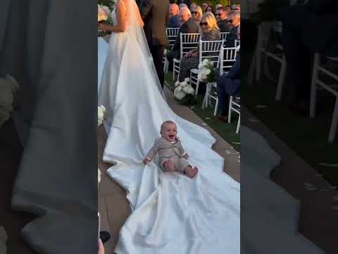 Baby takes a ride on the bride's dress! 🤣 Best wedding moment! 👰‍♀️ #funnykids #wedding #shorts