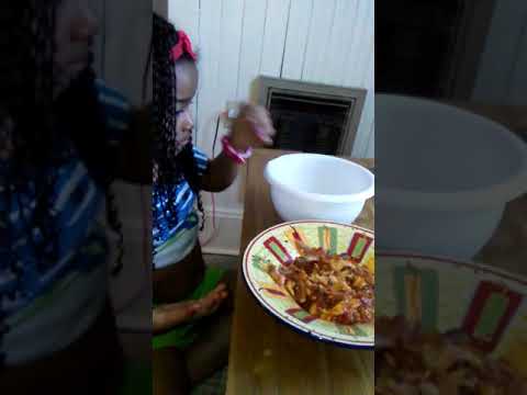 Parris eating Ghanaian food prepared by. Daddy