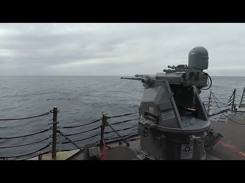 A Mark 38 mod 2 25mm machine gun is fired aboard the Arleigh Burke-class guided-missile destroye