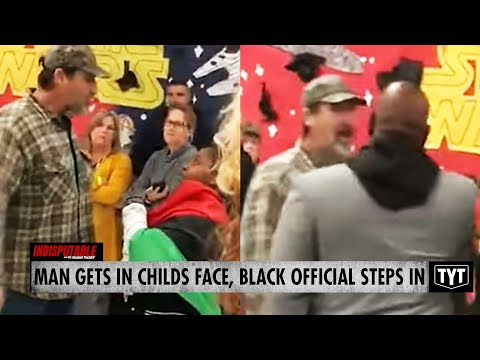 Black Official Steps In Between Man Confronting Child At School Meeting