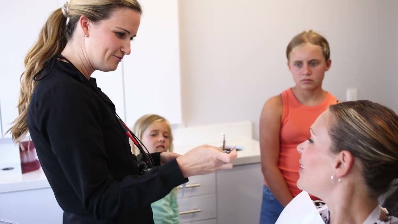 Blonde woman talking in Huntington Beach dental office