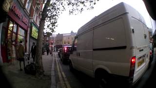 preview picture of video 'Cyclists filter through traffic when lights have just turned green'