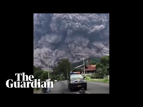 People flee as black cloud of volcanic ash towers above them in Guatemala