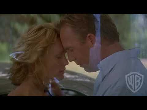 Message in a Bottle film shot of Theresa and Garrett standing together on a dock at sunset