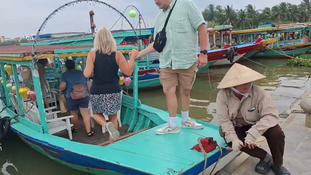Enchanting boats gently gliding along the Thu Bon River, surrounded by Hoi An's tranquil beauty and charm.