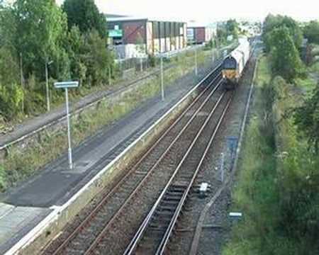 67013 departs Wrexham with 507019 in tow