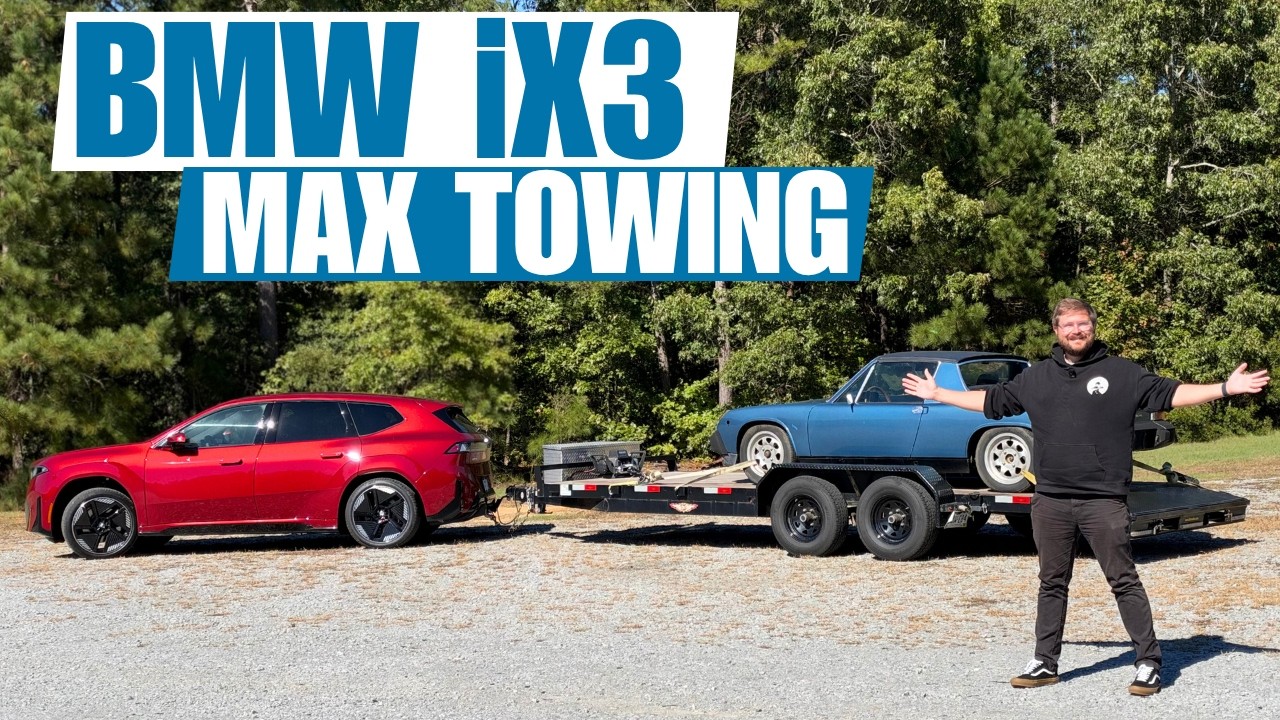 BMW iX3 towing a flatbed trailer carrying a Porsche 914