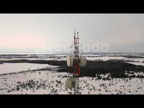 Drone shot of communications tower antenna stock video. Winter in Ontario, Canada. 4K Royalty Free.