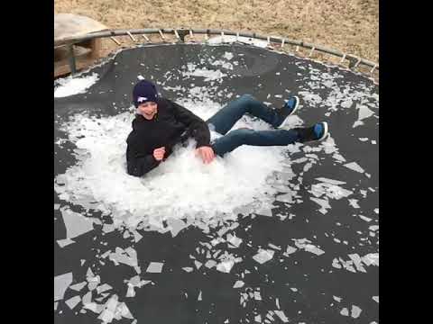 Slow-mo video of a kid landing on a frozen trampoline is insanely cool.