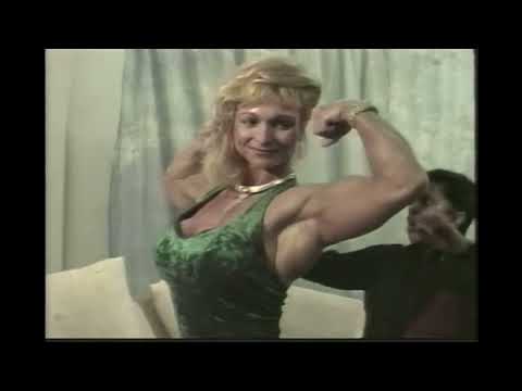 IFBB Pro Female Bodybuilder Judy Miller Flexes Her Muscles For A Small Weak Man